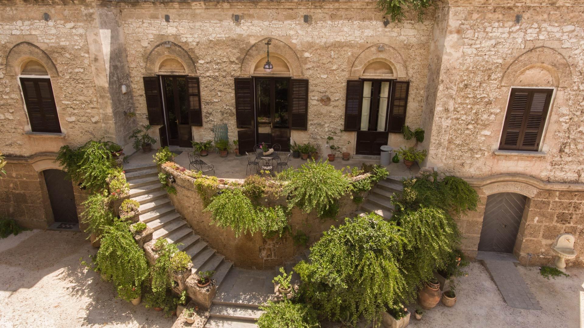 The planted stone courtyard of a converted historic building.