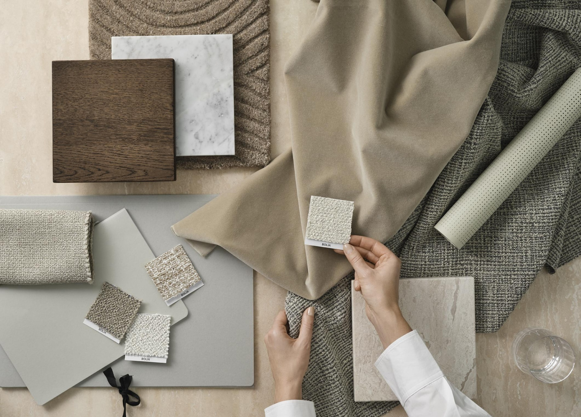 A considered arrangement of material samples in warm, neutral tones.