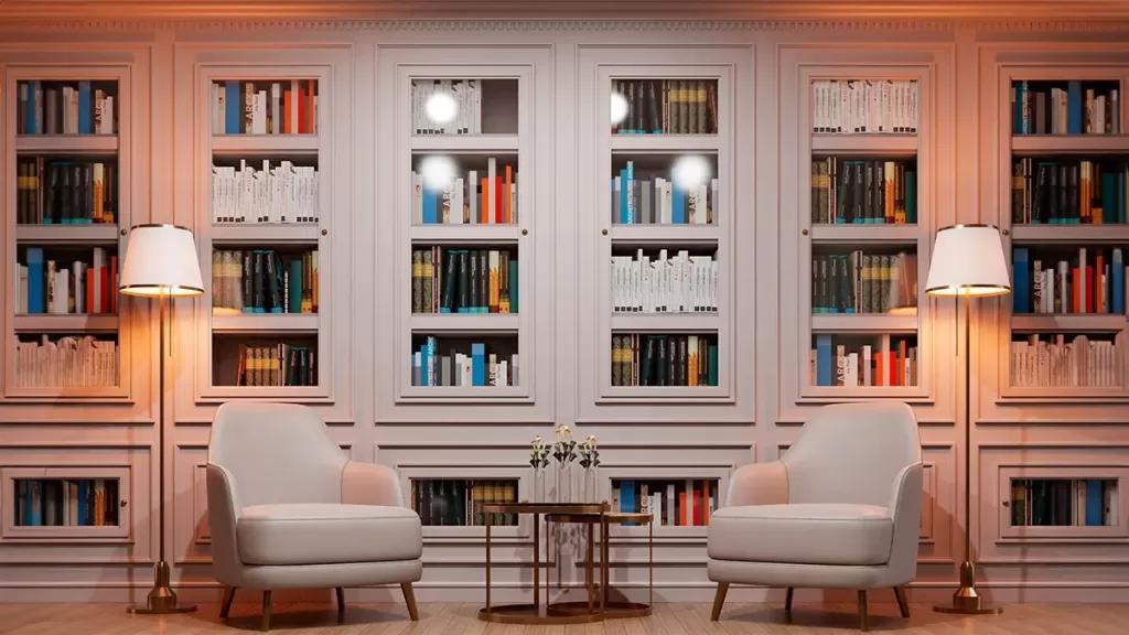 A symmetrical library room with pale shelving and two armchairs.